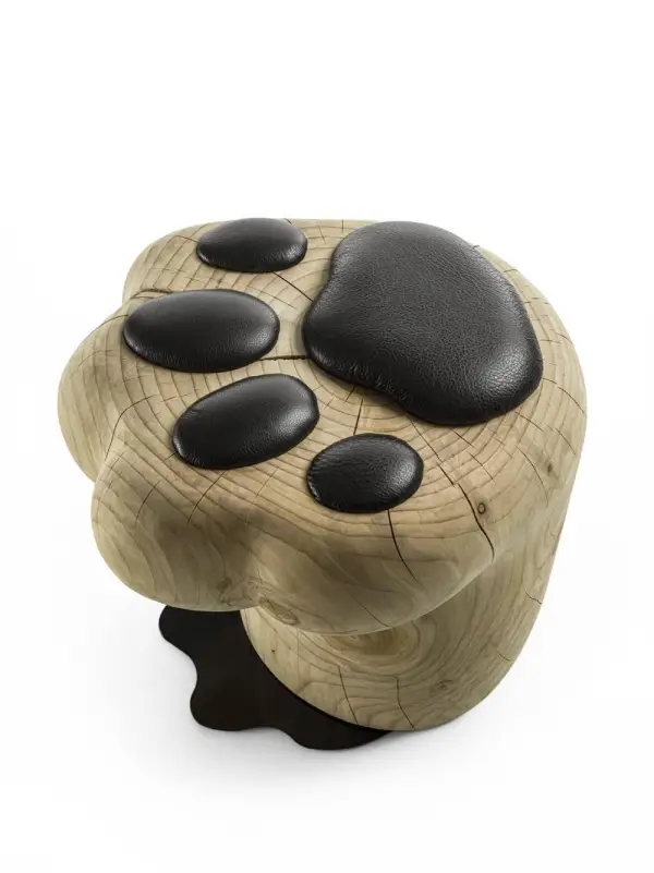 Taburete de cedro macizo inspirado en la forma suave y felina de una pata de gato